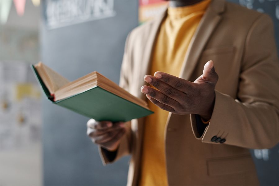 history teacher teaching from history book