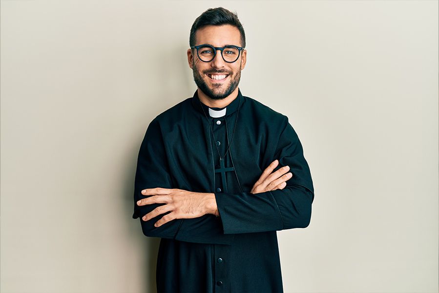 attractive priest crossing his arms
