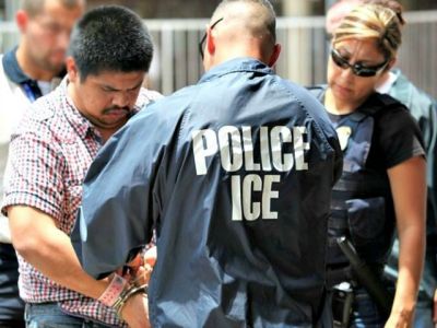A man being detained by an ICE agent