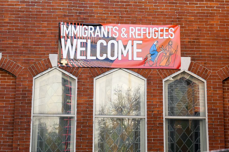 immigrants and refugees welcome sign on church