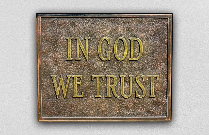 A sign that says 'In God We Trust'