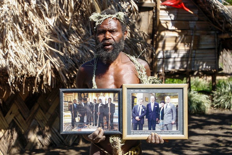 Indigenous man holding prince philip photo