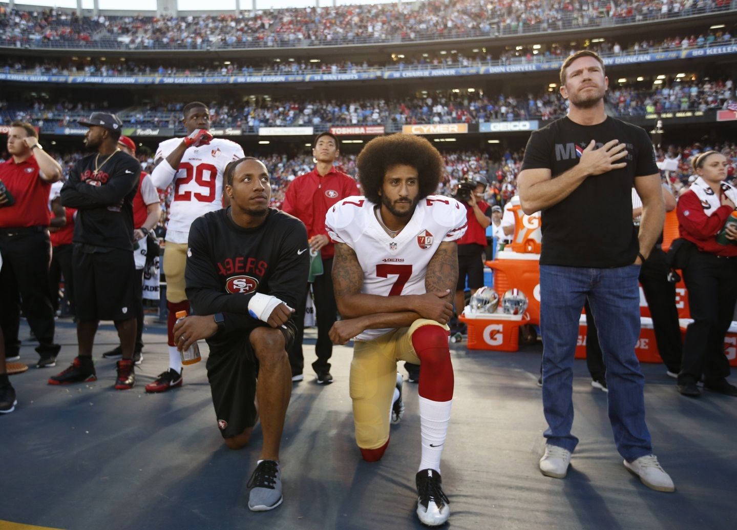 San Francisco 49ers quarterback Colin Kaepernick kneels on the sideline during the national anthem.