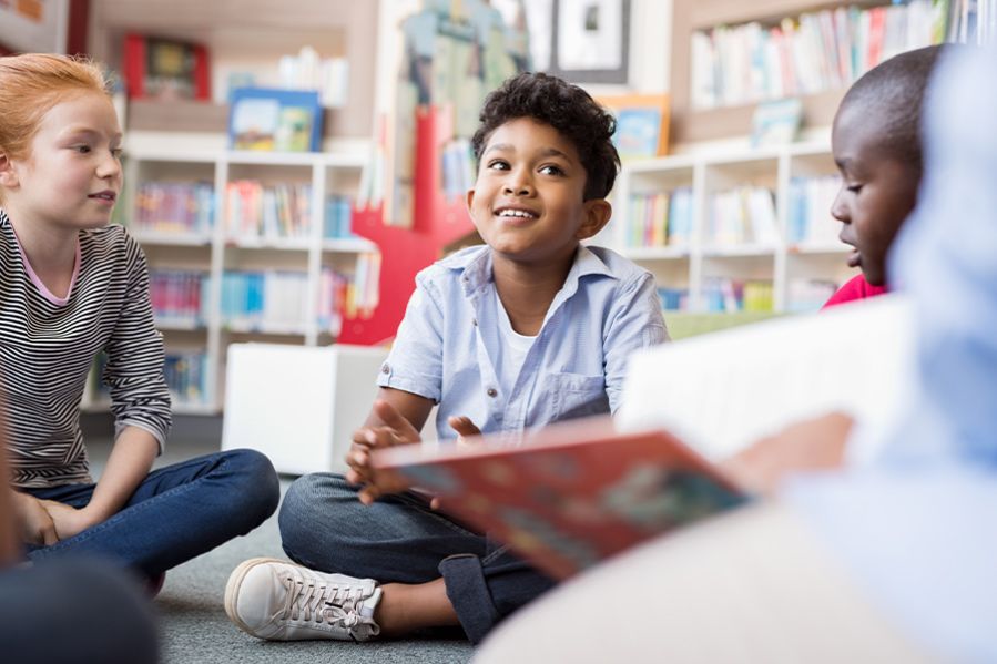 group of kids being read a story at library