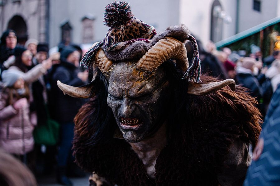 man in krampus costume during parade