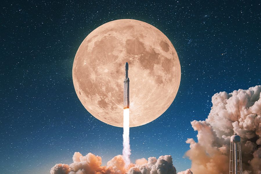 rocket launching at night with moon in background