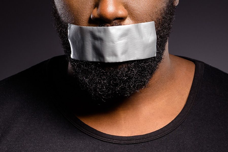 man with tape over his mouth