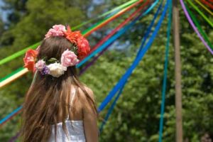 May Day Beltane Pagan Holiday Girl dancing around a may pole