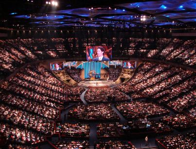 A pastor addresses congregation at megachurch.