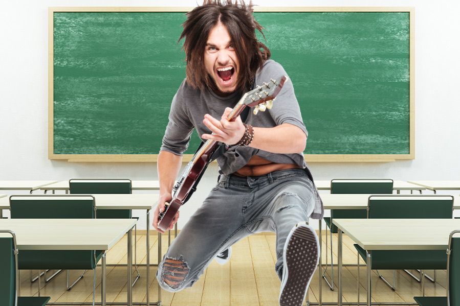 teacher in classroom playing guitar