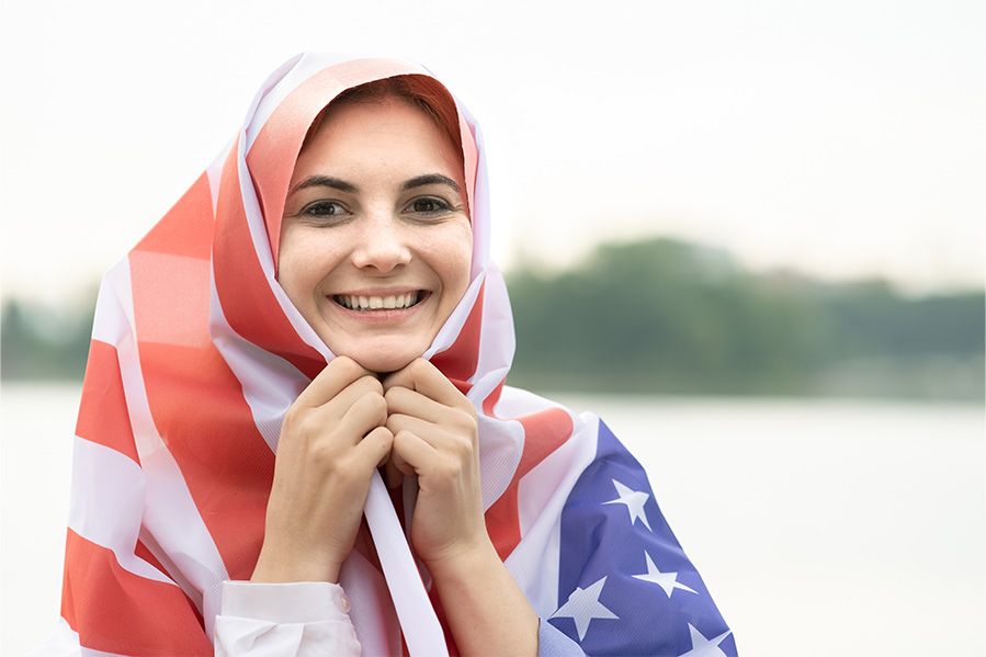 Smiling Muslim woman wearing American flag hijab