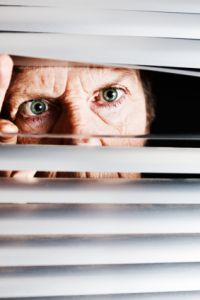 angry neighbor peeking through blinds