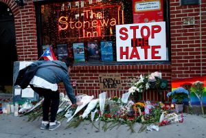 Flowers being placed at a memorial in front of the Stonewall Inn in New York City
