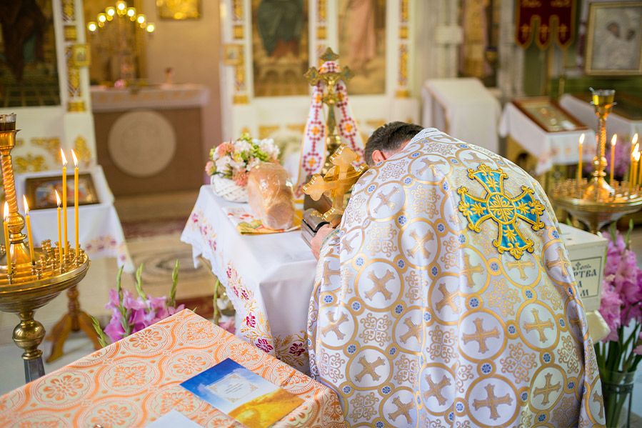 orthodox priest praying in church