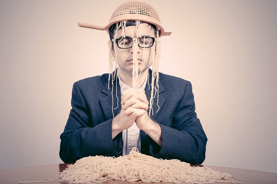 pastafarian man with colander on head praying