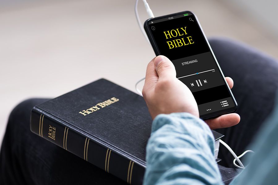 person listening to bible audiobook on phone