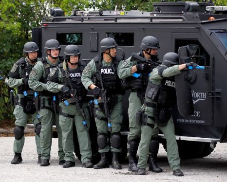 Police holding guns and riot gear