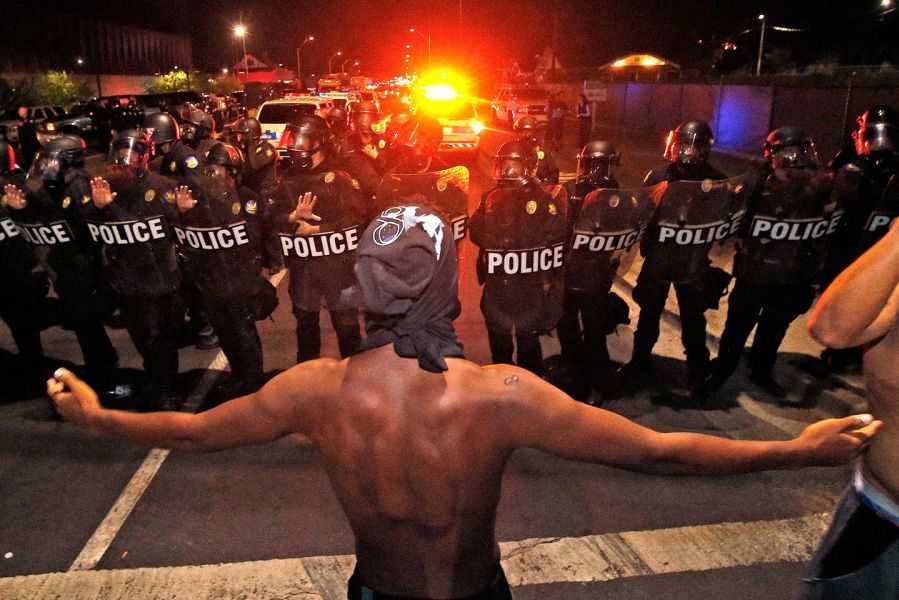A Black Lives Matter demonstrator faces off against police