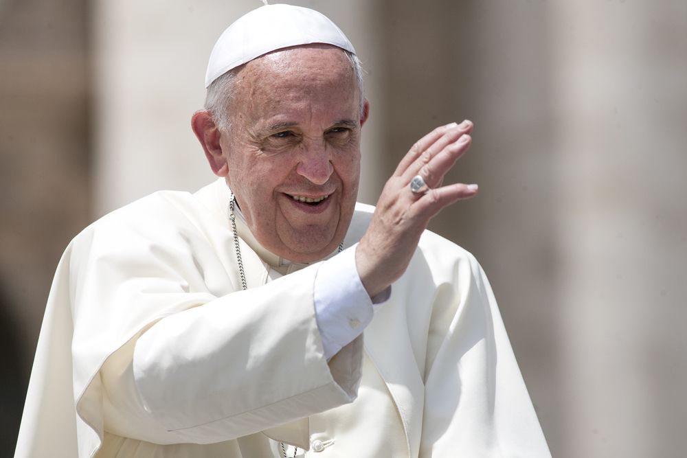 Pope Francis waving to a crowd