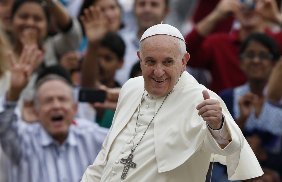 Pope Francis greets adoring crowds with a thumbs up.