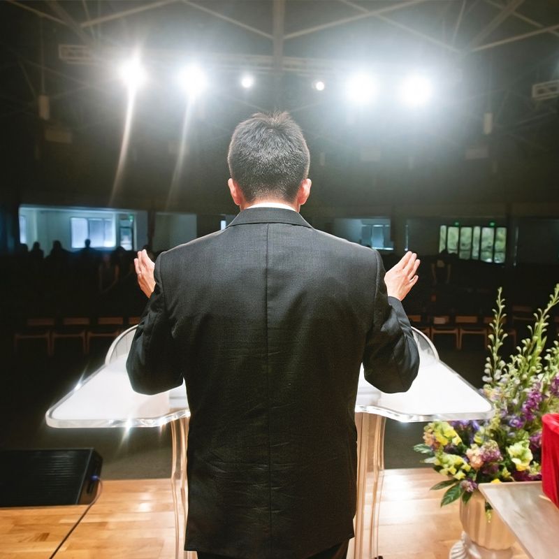 pastor delivering sermon in front of church congregation