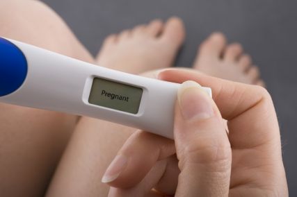 A woman holding a pregnancy test