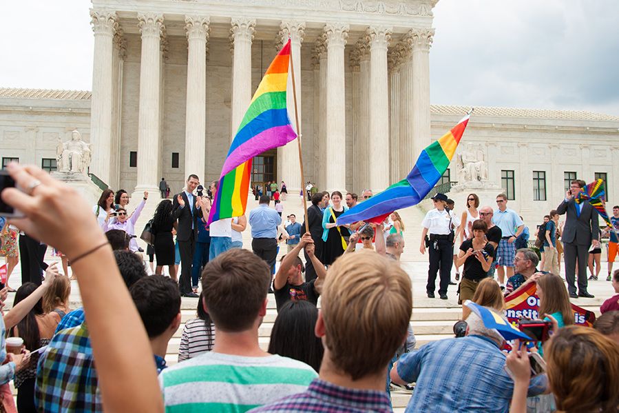 LGBT activists waving pride flag outside supreme court following obergefell ruling