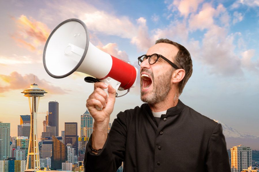 Priest with megaphone in front of Seattle skyline