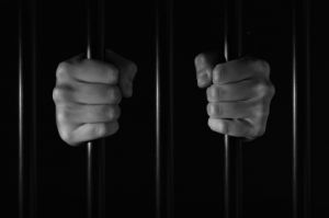 prisoner's hands holding bars