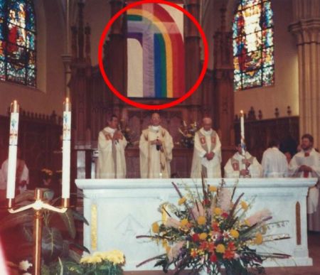 A rainbow flag banner hanging in a Chicago Catholic Church
