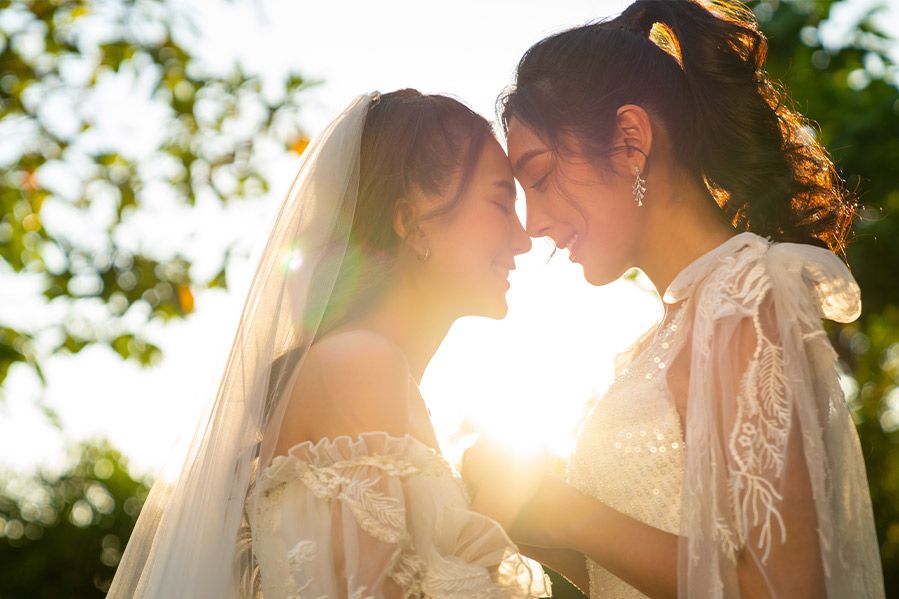 two female brides embracing at wedding