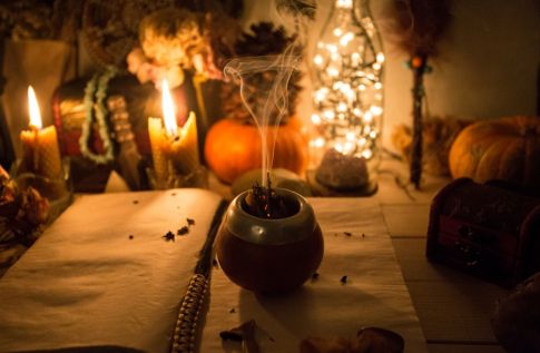 pumpkins and candles on table for samhain