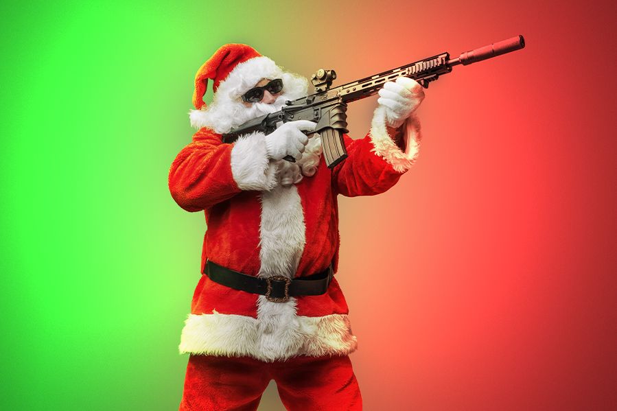 santa firing machine gun on red and green background