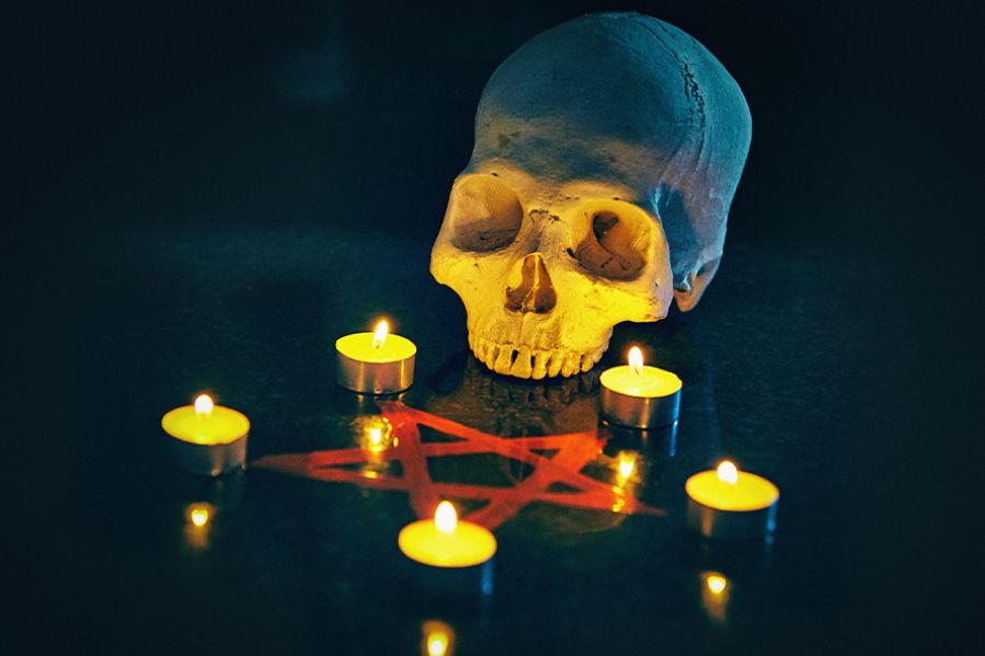 skull and tea lights around pentagram, satanic altar