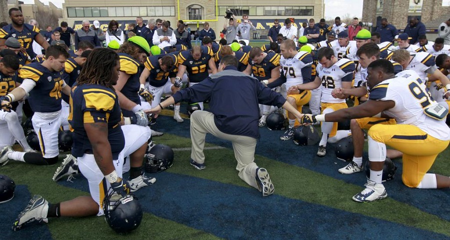 Prayer circle on a football field