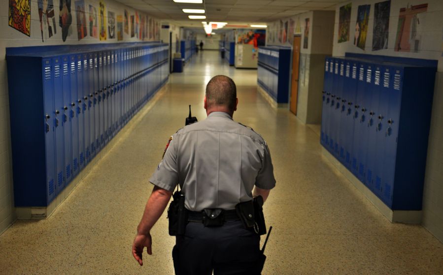 A school police officer walks the halls.
