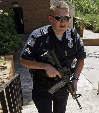 A school police officer holding a rifle