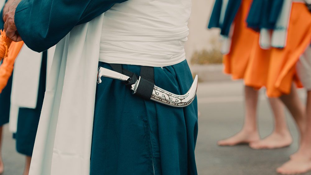 A kirpan worn at the waist of a Sikh man