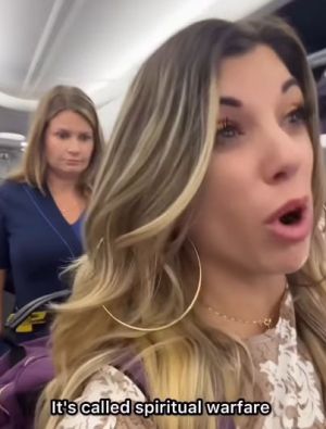 Evangelist Whitney Lynn speaks to a flight attendant and her Instagram audience as she is escorted from a plane.