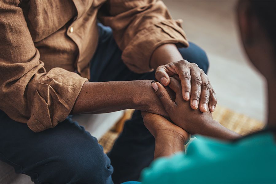 couple holding hands in support of one another