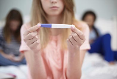 Teenage girl with pregnancy test