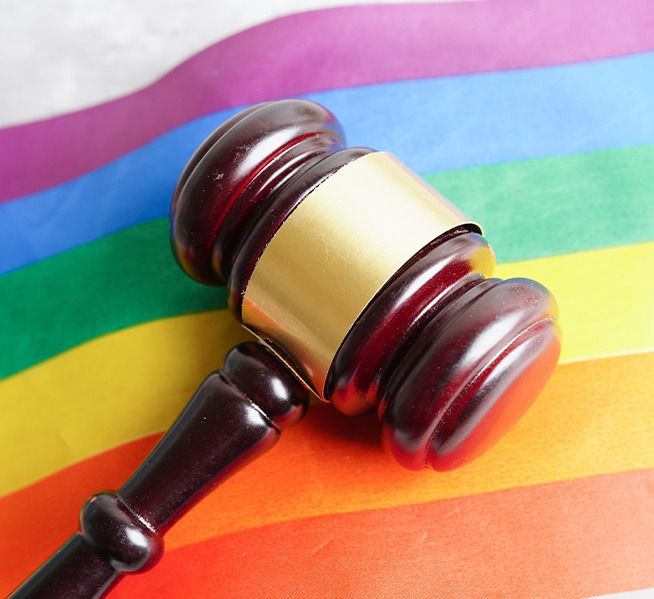 legal gavel resting on LGBTQ pride flag