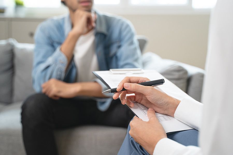 therapist taking notes during session with lgbt client