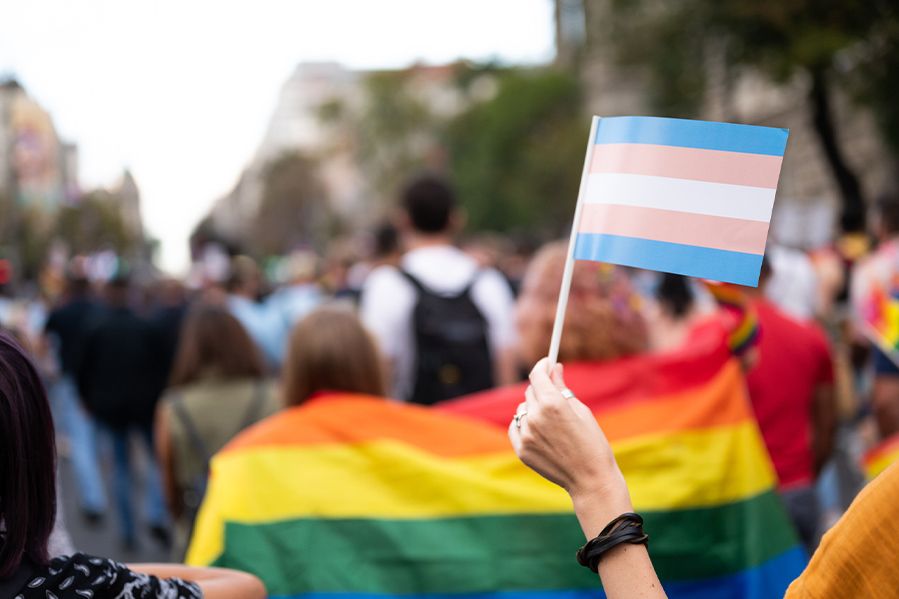 transgender pride flag being held at pro lgbtq rally
