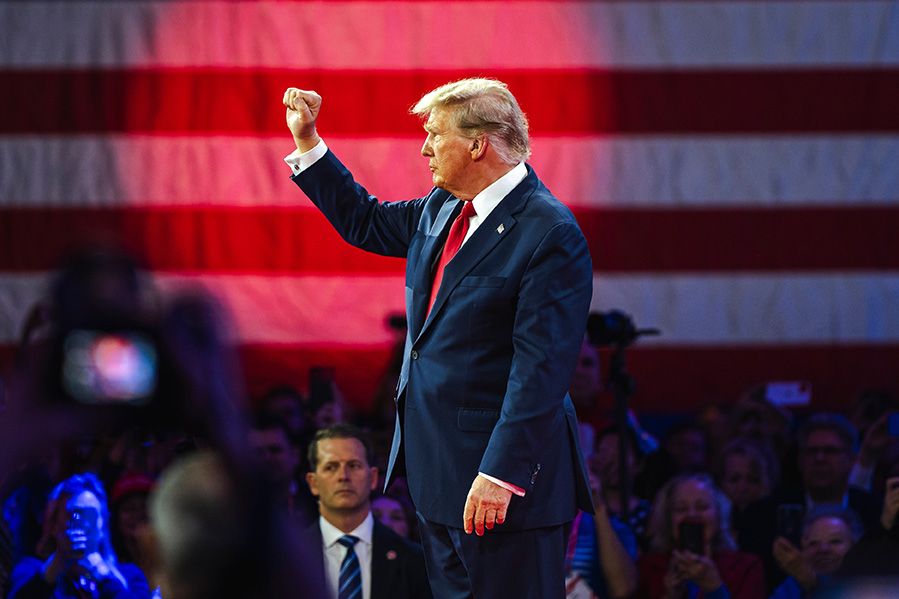 Donald Trump hold hand aloft at rally