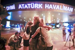 Passengers embrace each other at the entrance to Istanbul's Ataturk airport