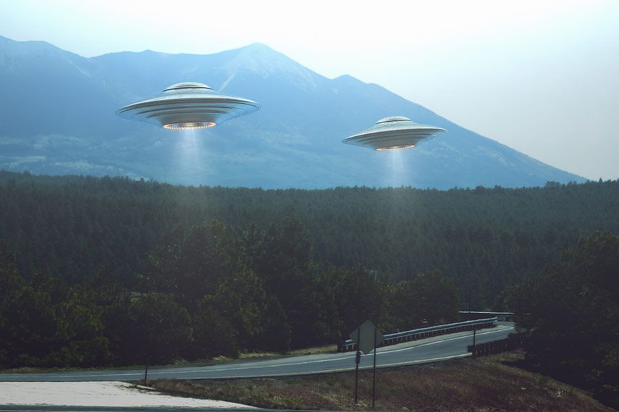 UFOs over wooded road