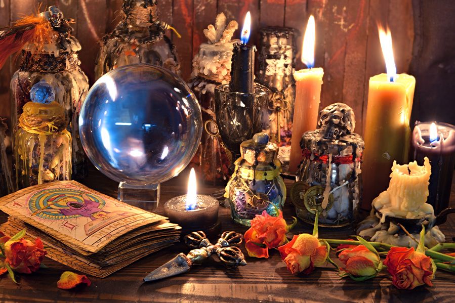 voodoo ritual including divination books and crystal ball