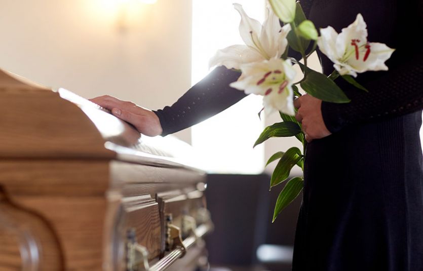 Woman paying respects at funeral