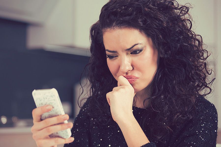 Upset woman looking at her phone